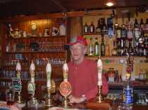 Pete the Landlord behind the Charity's bar